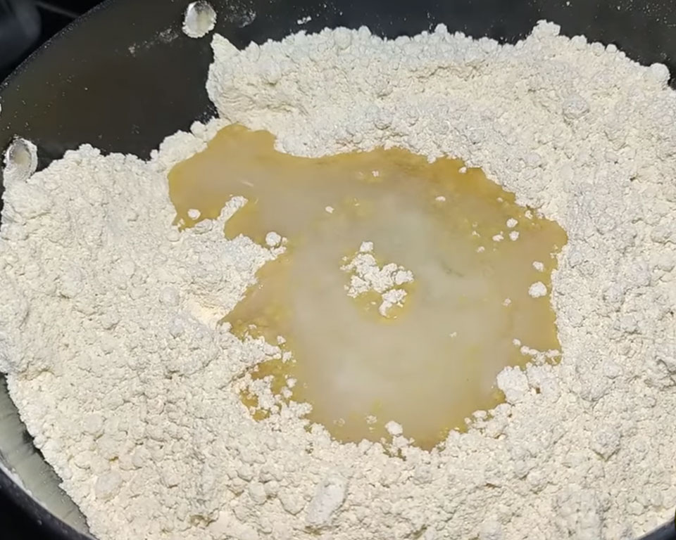 Adding ghee to roasted besan