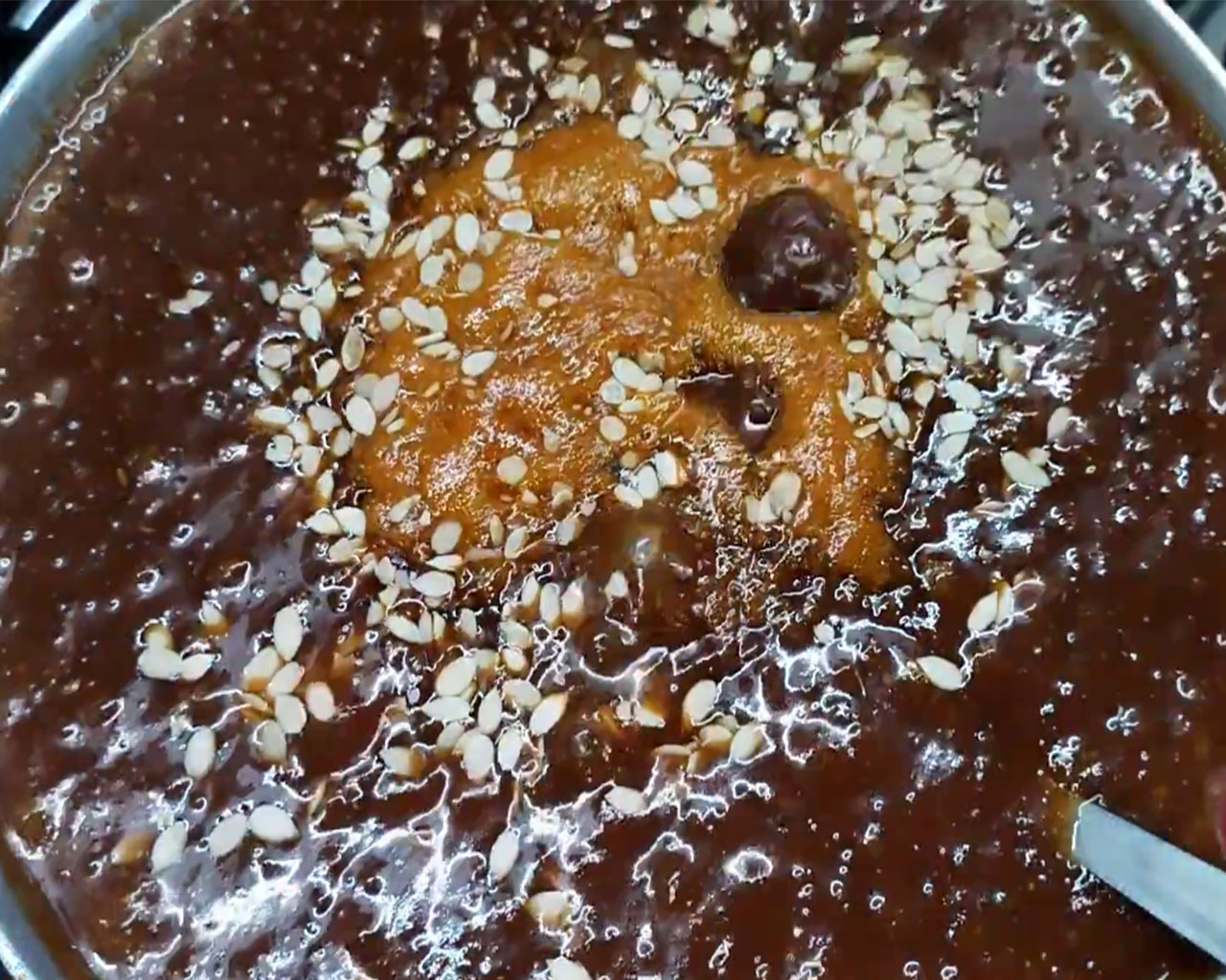 Melon seeds being added to tamarind chutney for added texture
