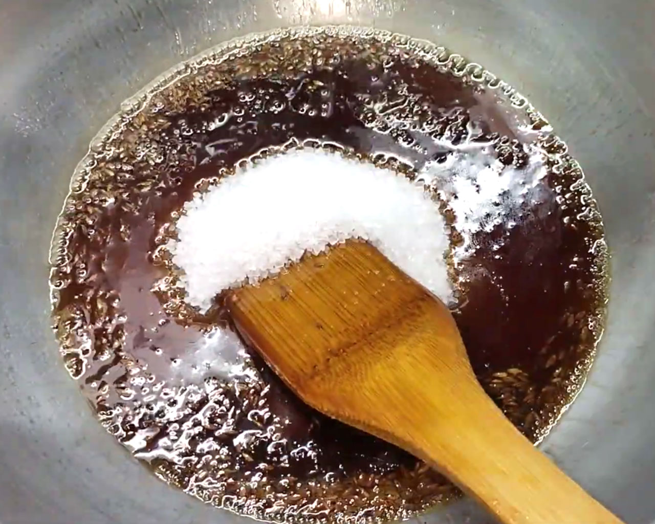 Sugar added to tamarind jaggery syrup for sweet and tangy chutney