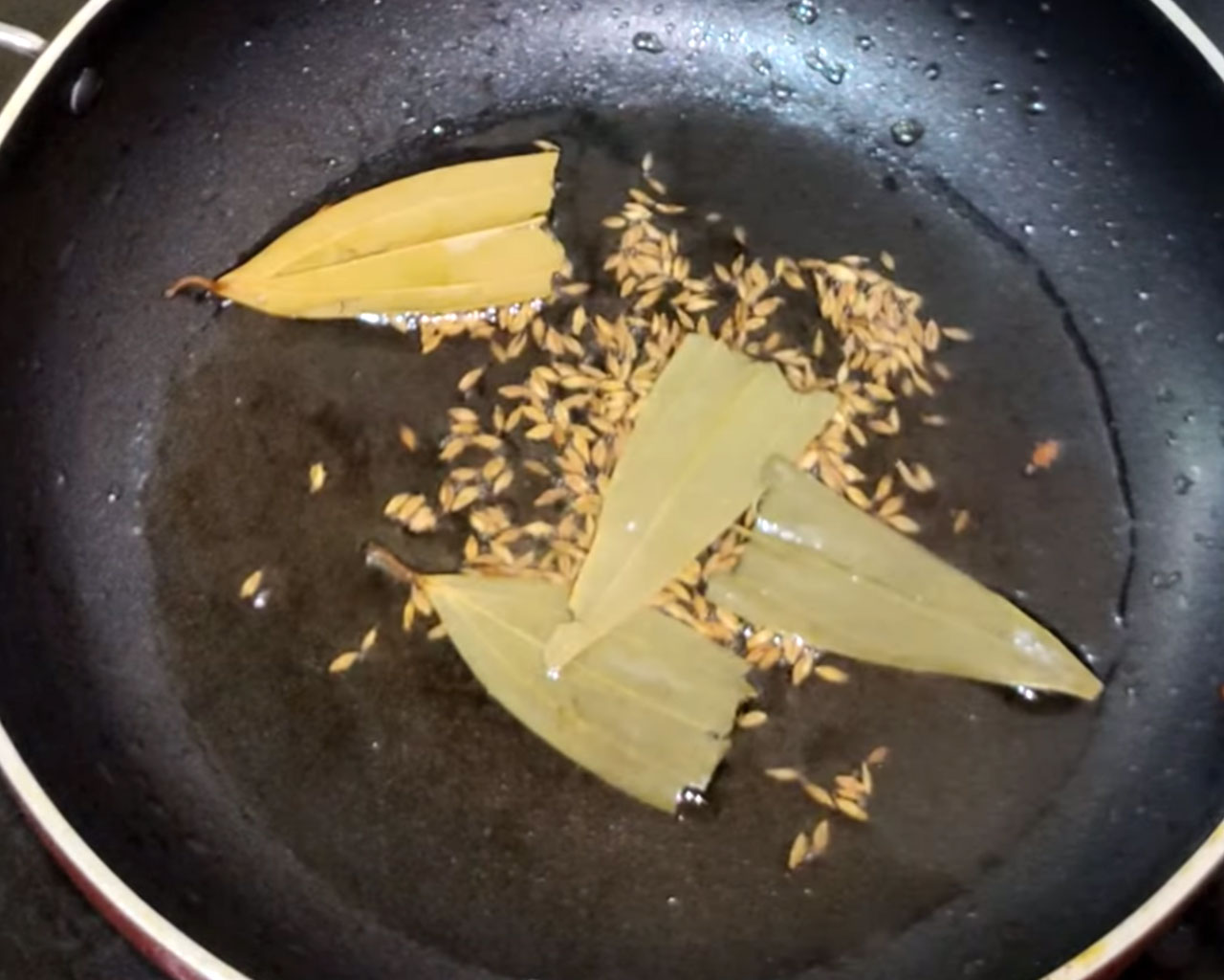 Bay leaves frying in pan for matar paneer