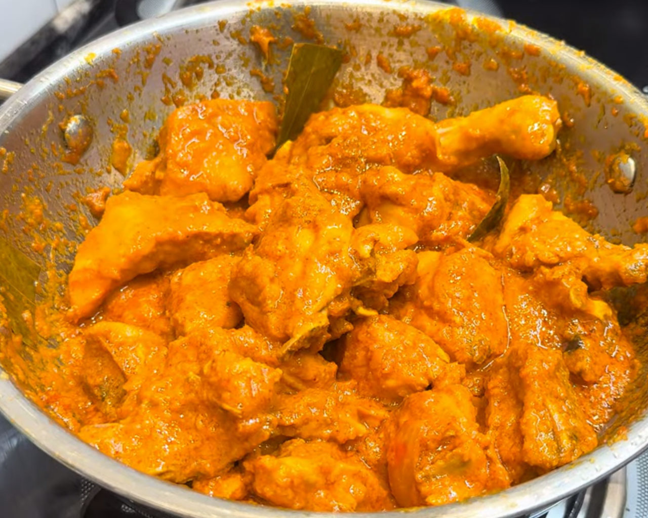 Marinated chicken being cooked to make Indian chicken curry