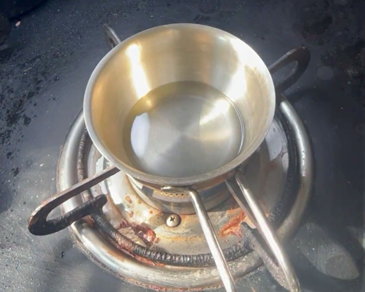 Oil heating in a tadka pan for onion chutney tempering