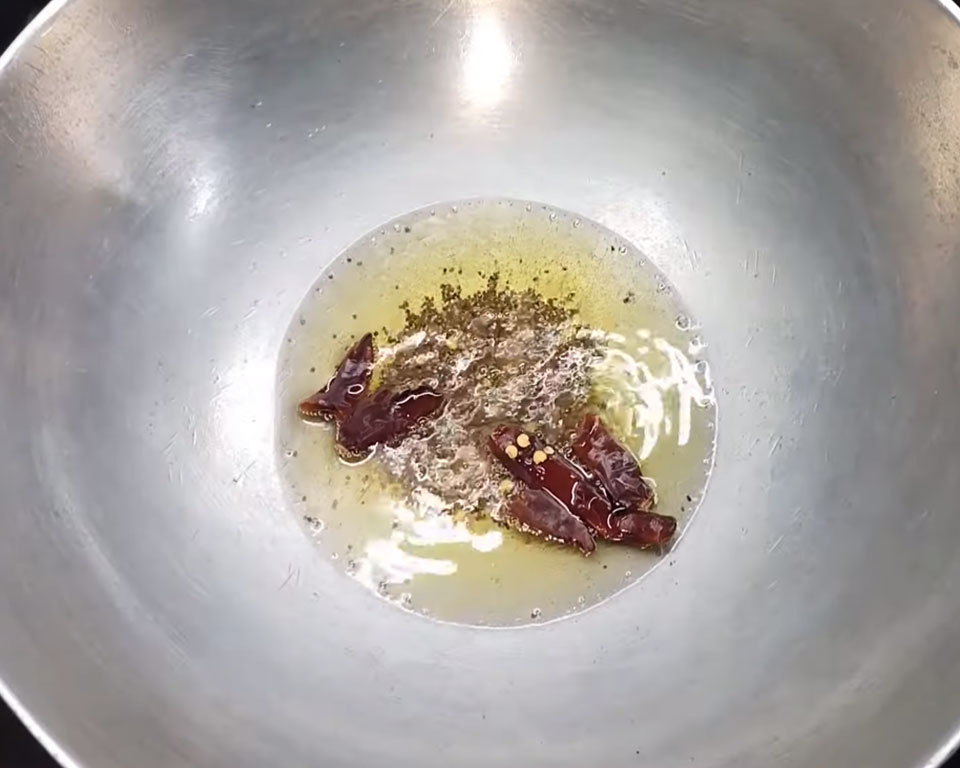 South Indian tempering with mustard seeds, asafoetida, dried red chilies sizzling in hot oil for authentic sambar