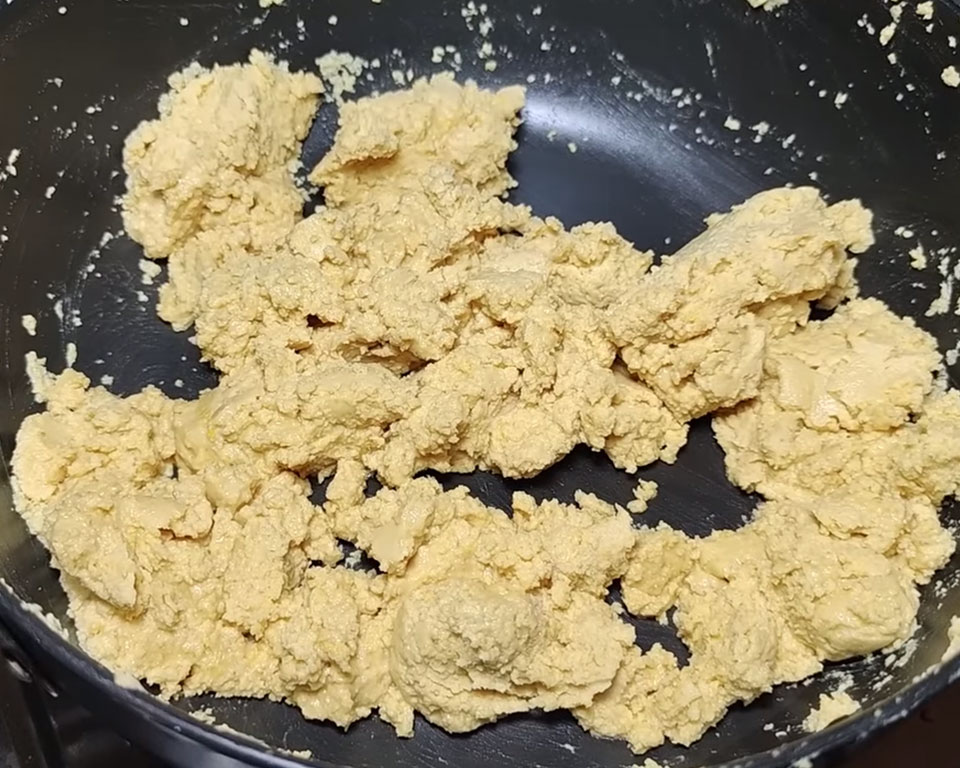 Stirring the besan mixture continuously for Indian besan laddu texture