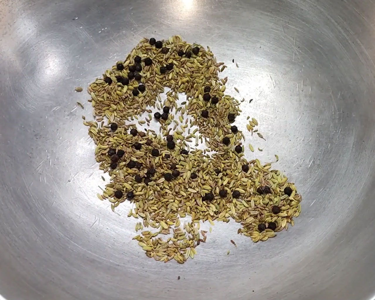 Roasting black pepper, cumin seeds and fennel seeds to prepare spice mix for tamarind imli chutney