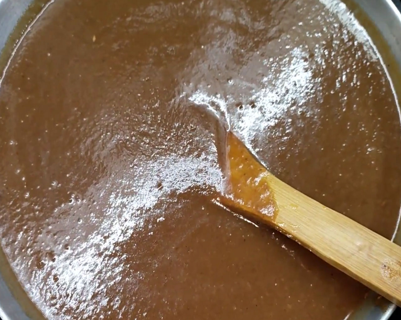 Mixing tamarind paste and syrup for authentic Indian imli chutney