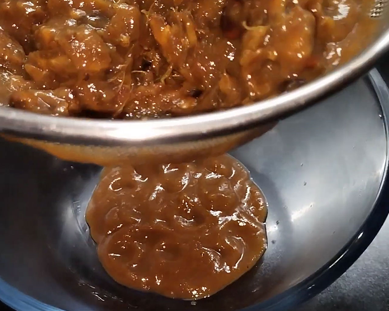 Sieving soft tamarind pulp to extract thick paste for tamarind chutney