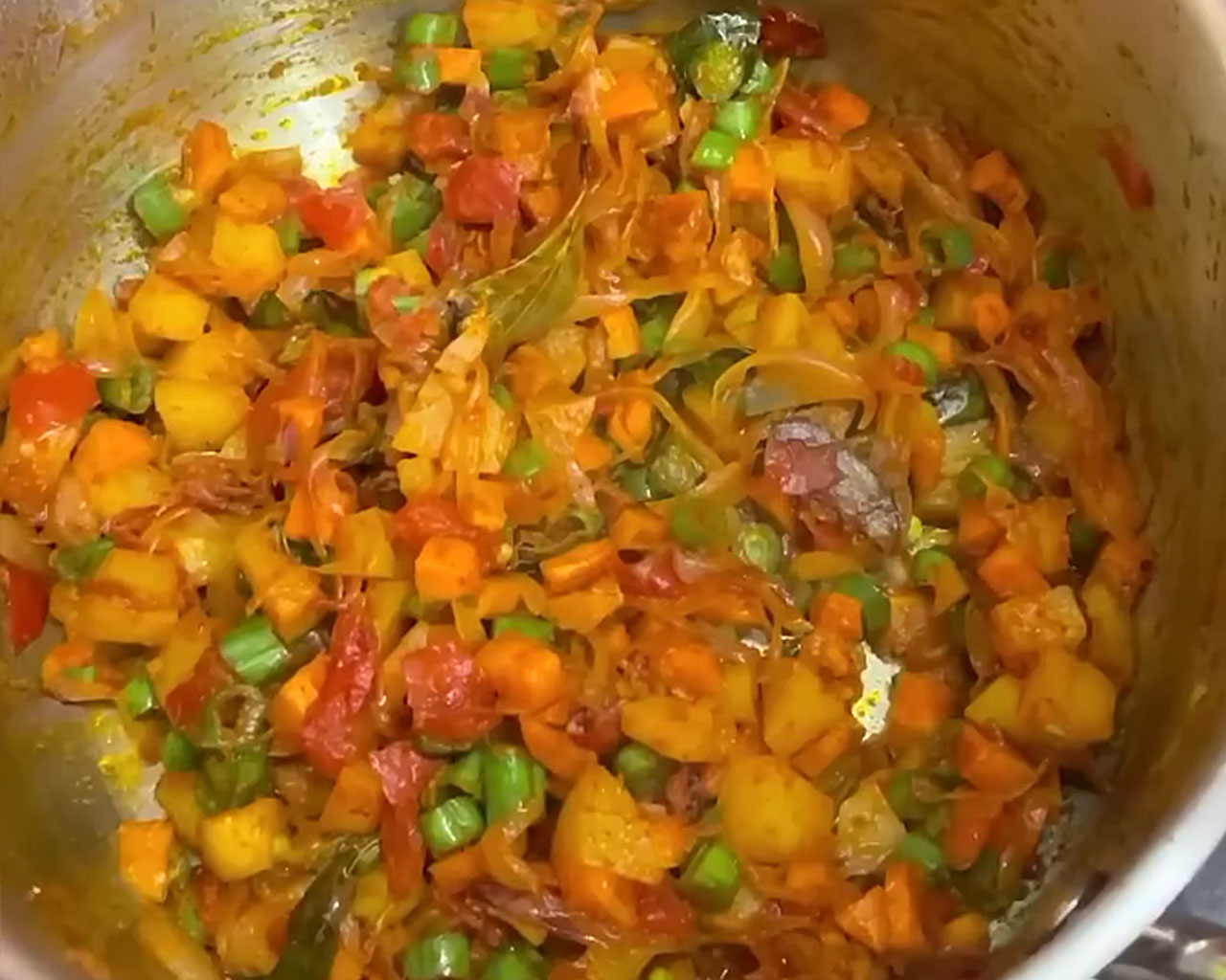 Vegetables being cooked in the spices for veg kurma curry base