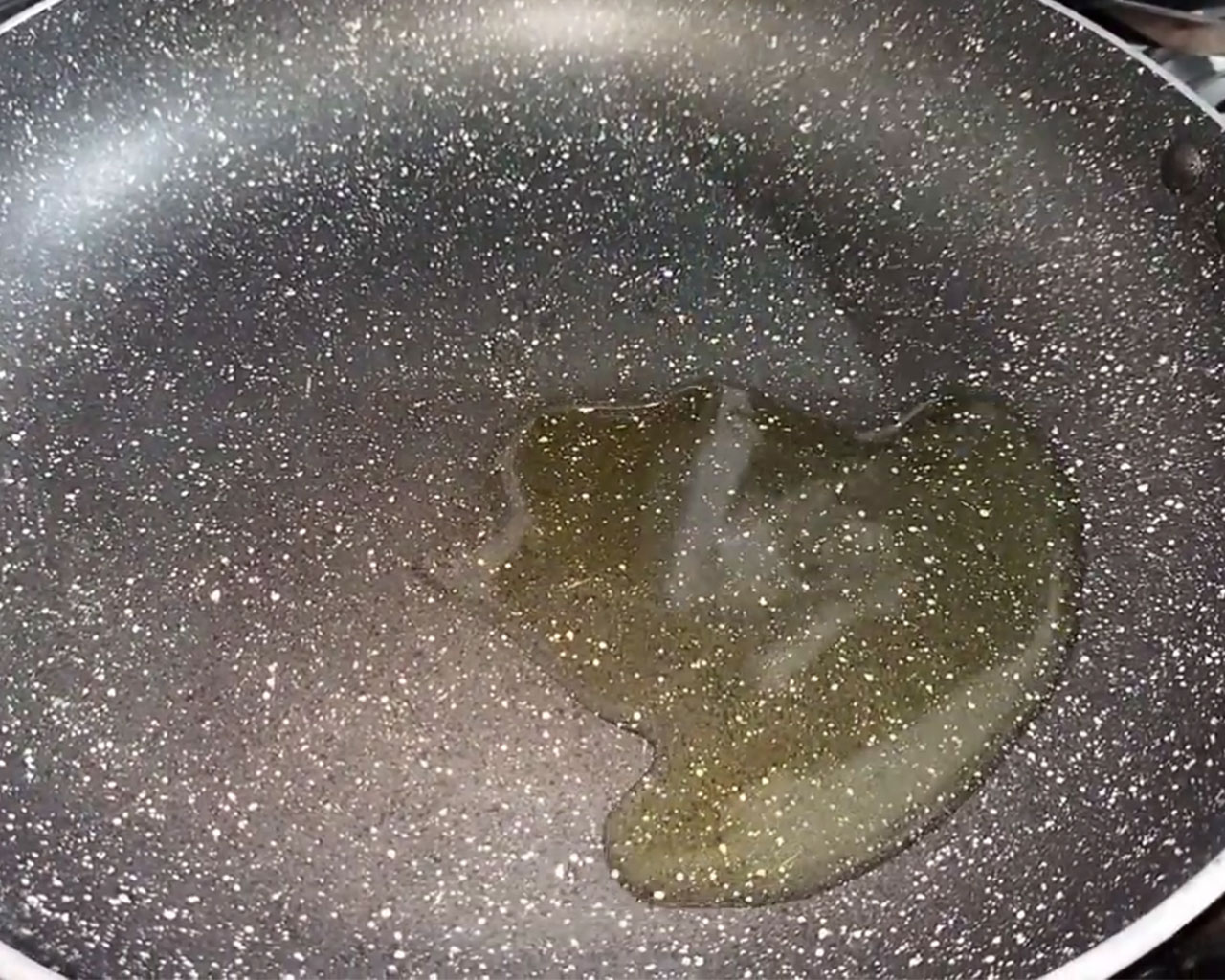 Heating oil in a pan on high flame for tomato chutney preparation