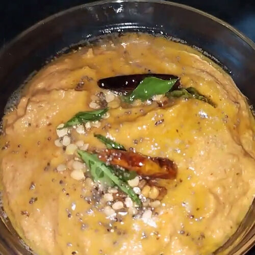 tomato chutney with tadka in a glass bowl