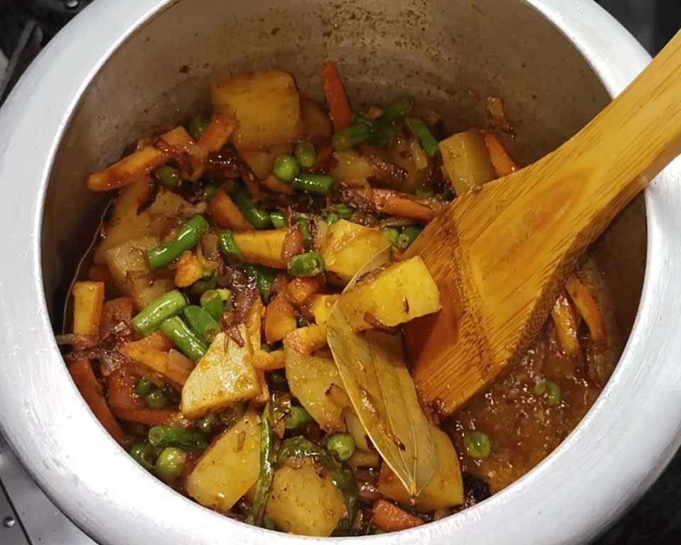 Turmeric, coriander, cumin powder, and garam masala sprinkled over vegetables