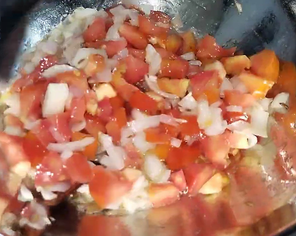 Sautéing whole spices with onions and tomatoes in butter for Indian curry .