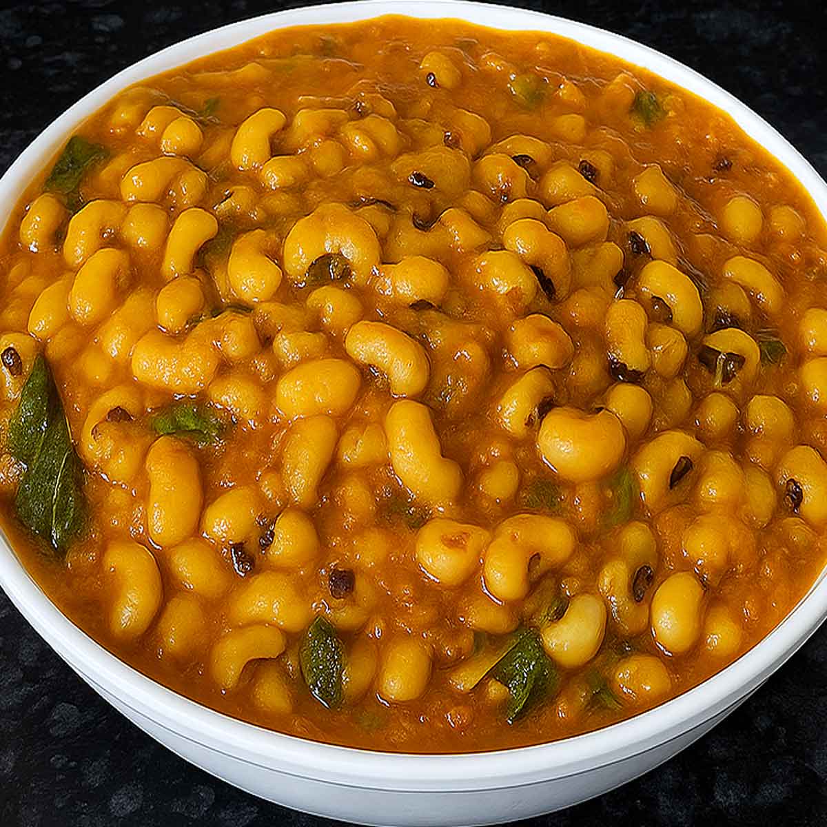 Close-up of lobia recipe in a bowl, Indian-style black eyed peas curry with aromatic spices, protein-rich ingredients.