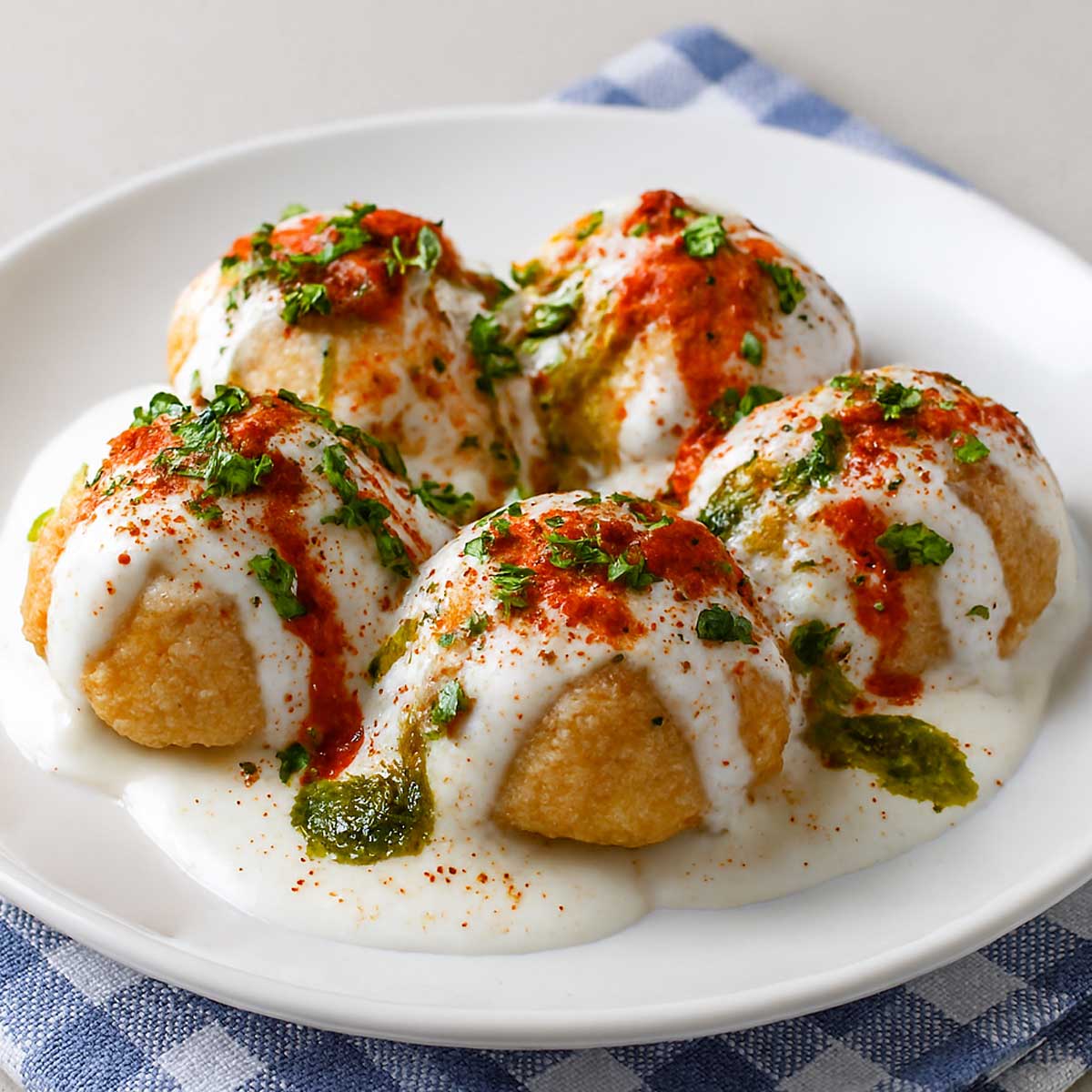 Vegetarian soft Dahi Vada dish with lentil fritters, yogurt, and spices ready to serve